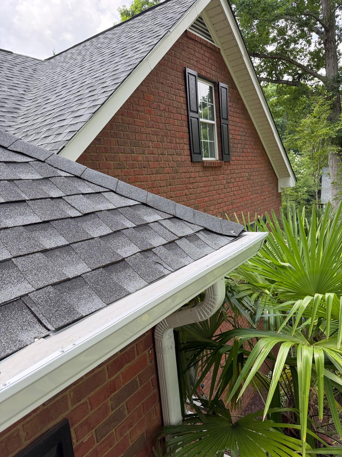 ValueFilter gutter guard installed along roofline near brick home